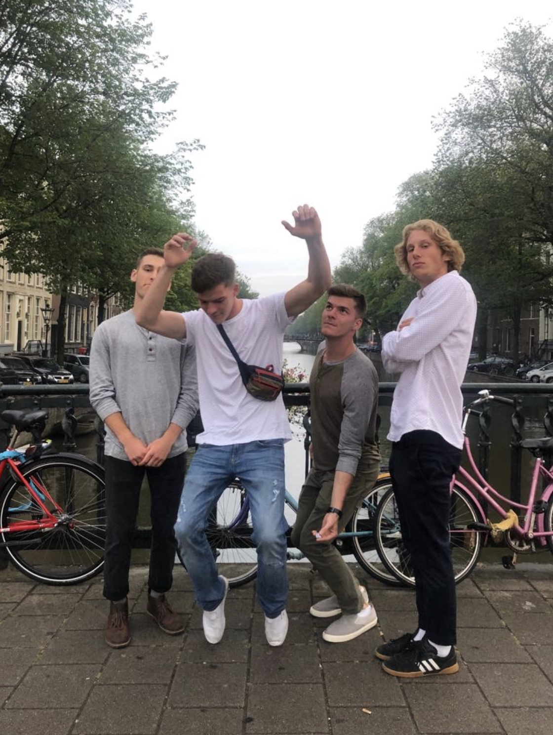 The four members of the posse, arms raised, on a bridge before their last great ride.
